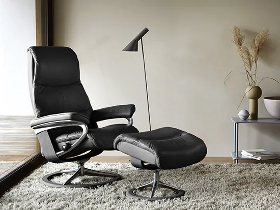 Fauteuil relax Stressless View en cuir noir avec repose-pieds, présenté dans un salon – Meubles Bouchiquet à Bergues (59)