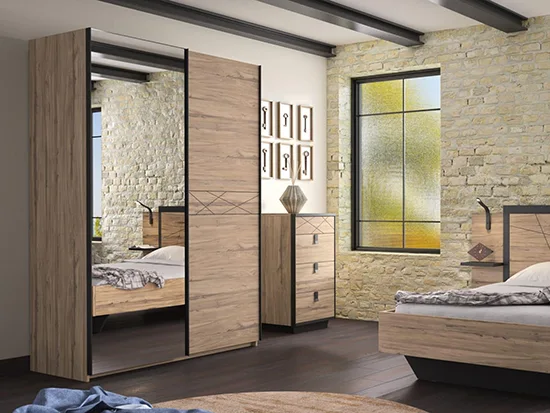 Lit bois et métal noir avec armoire à portes coulissantes dans une chambre lumineuse
